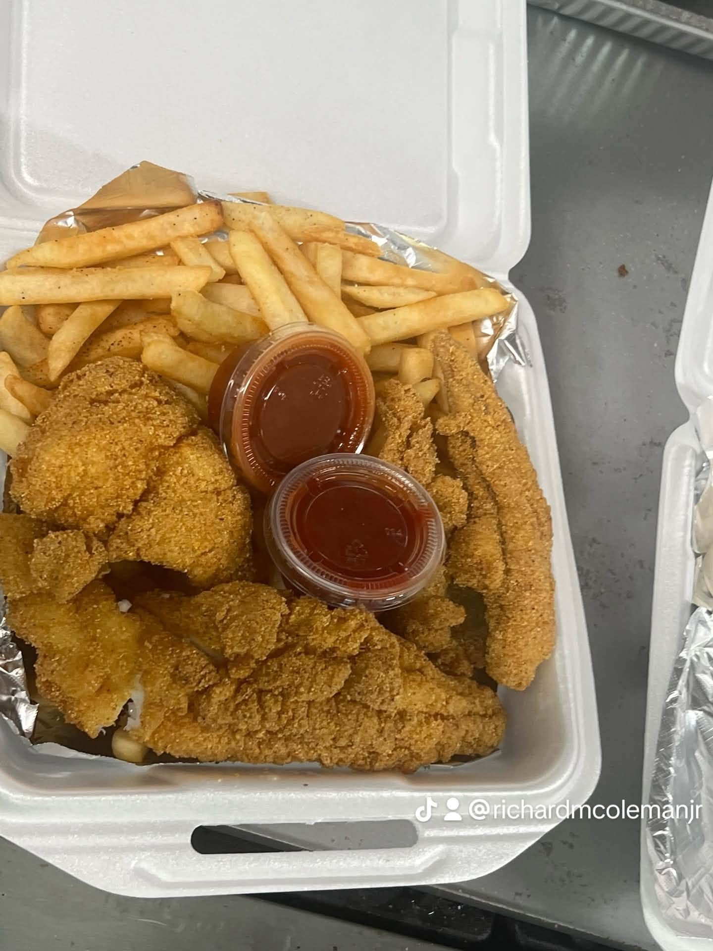 Fried fish and fries served with dipping sauces