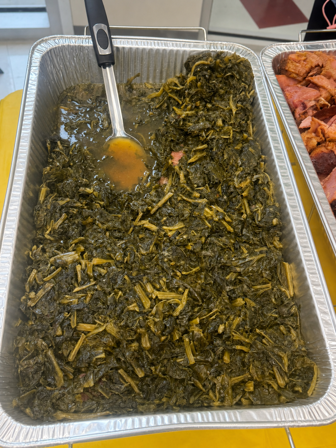 Mixed greens in a catering tray