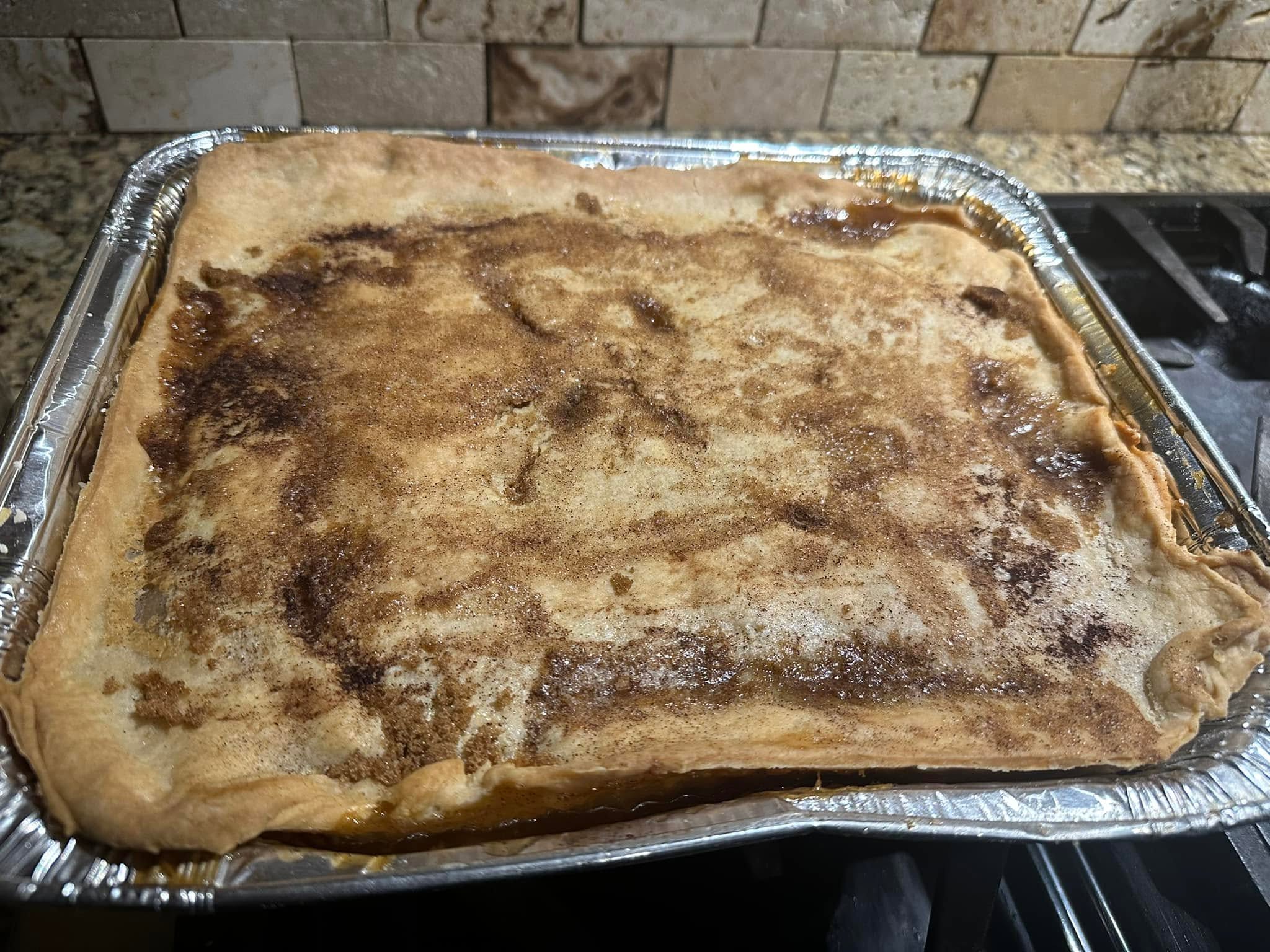 A large baked dessert pie in a catering pan